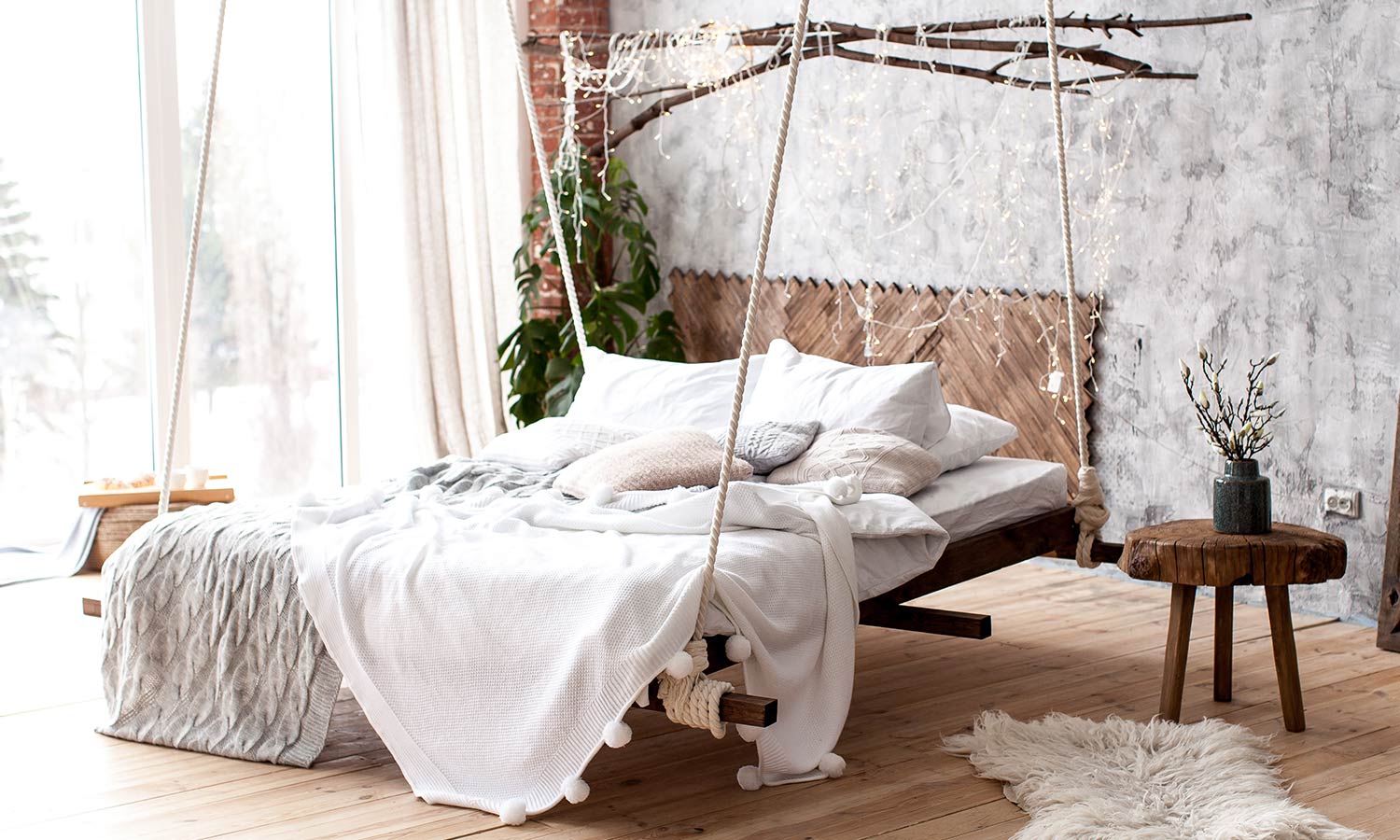 A whimsical hanging bed in a room with rustic wood accents.