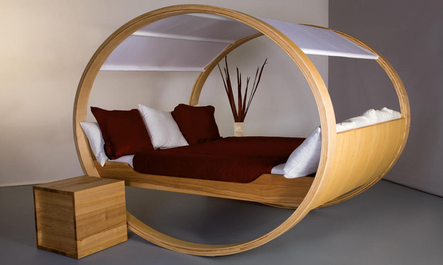 A bed with a vertically-round frame meant for rocking back and forth.