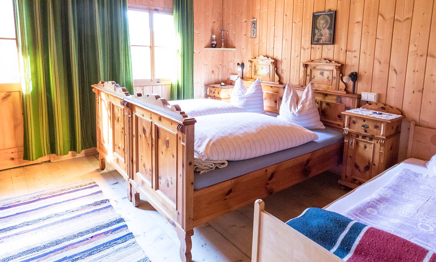 A bed made of un-stained, rustic wood