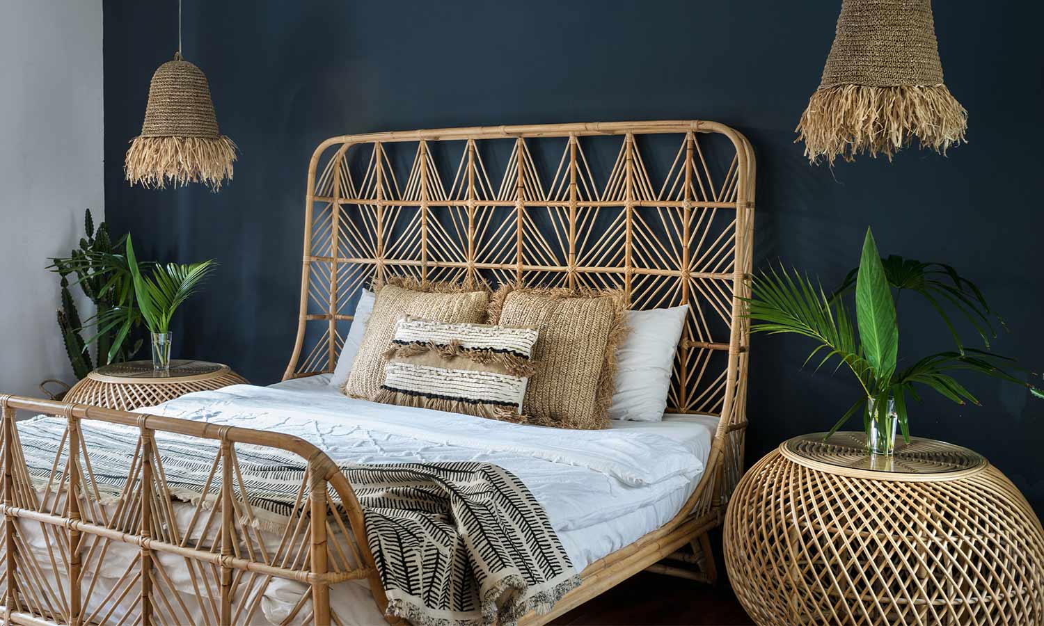 A light-colored bedframe with woven wicker in the headboard and footer.