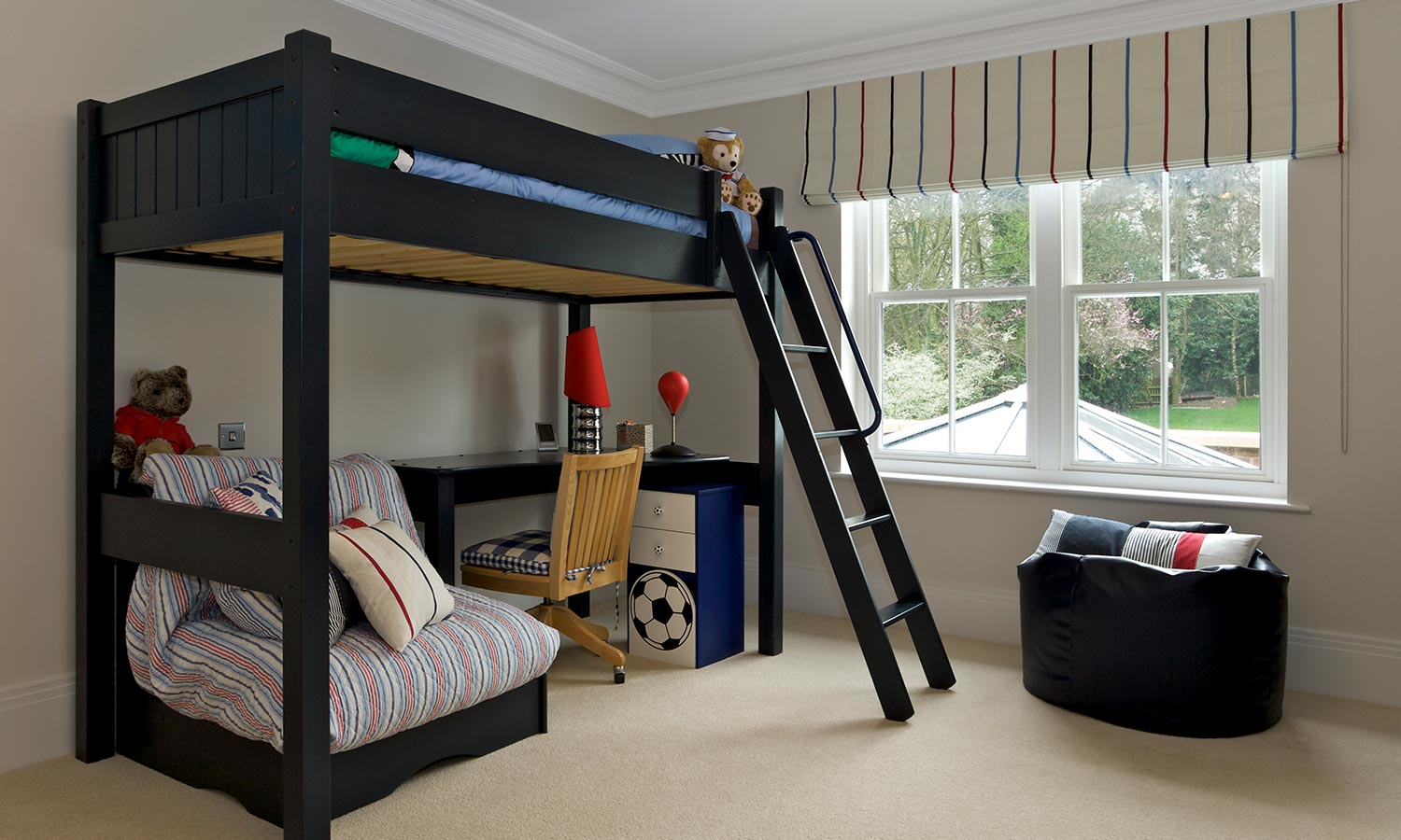 A lofted bunk bed with desk underneath