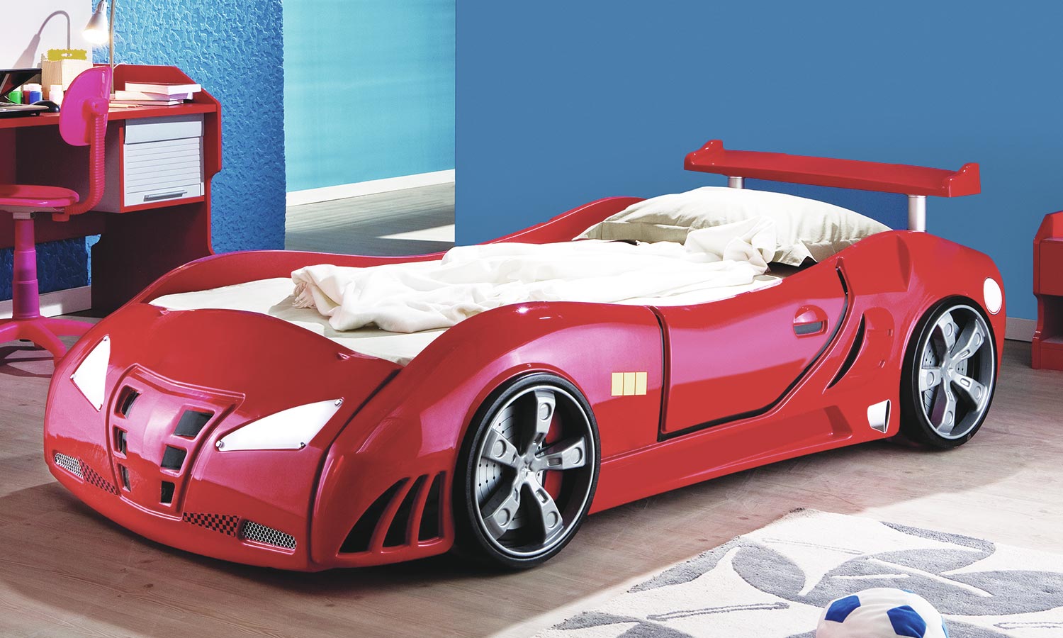 A small children's bed shaped like a car