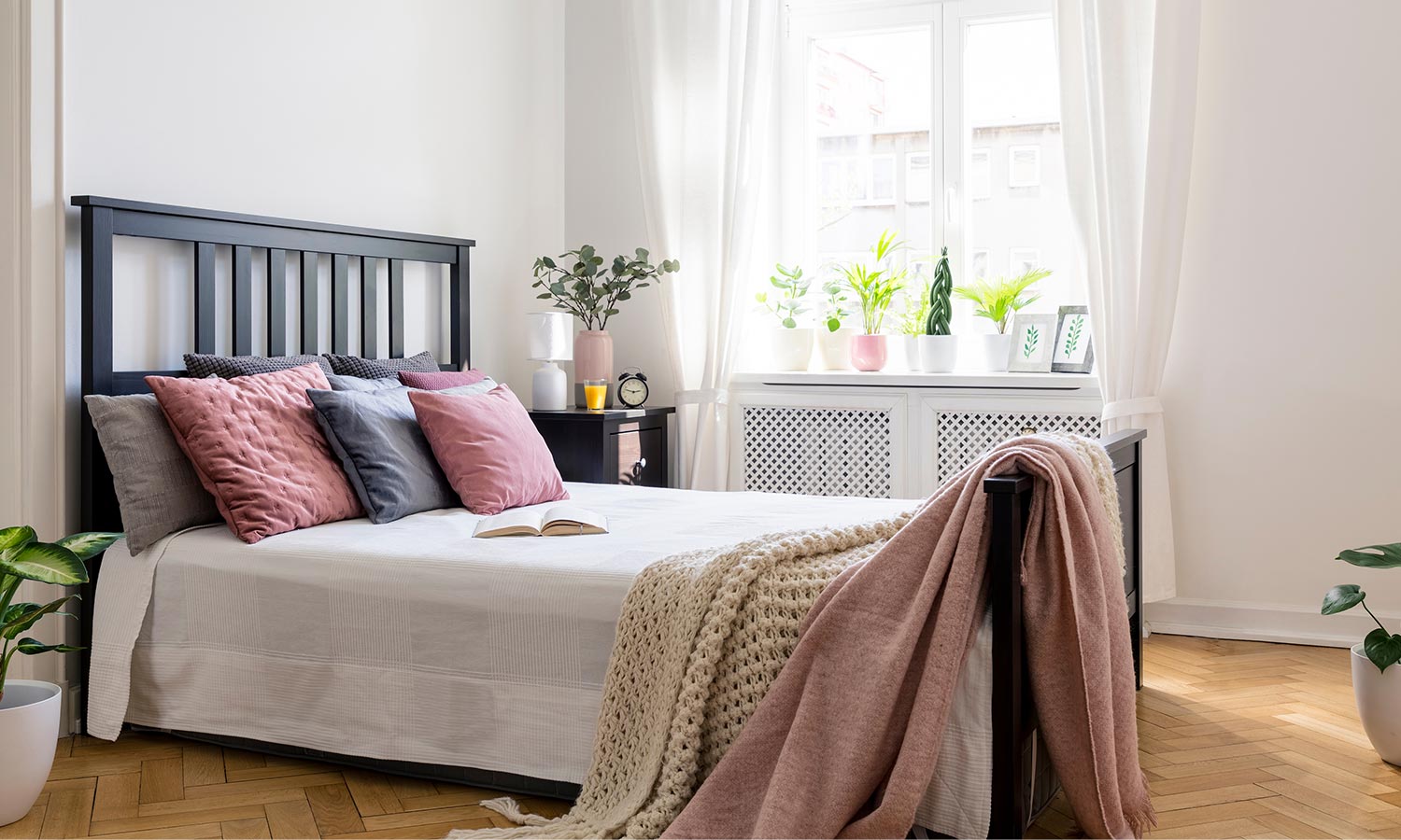 A black-painted wood frame with slats in the headboard.