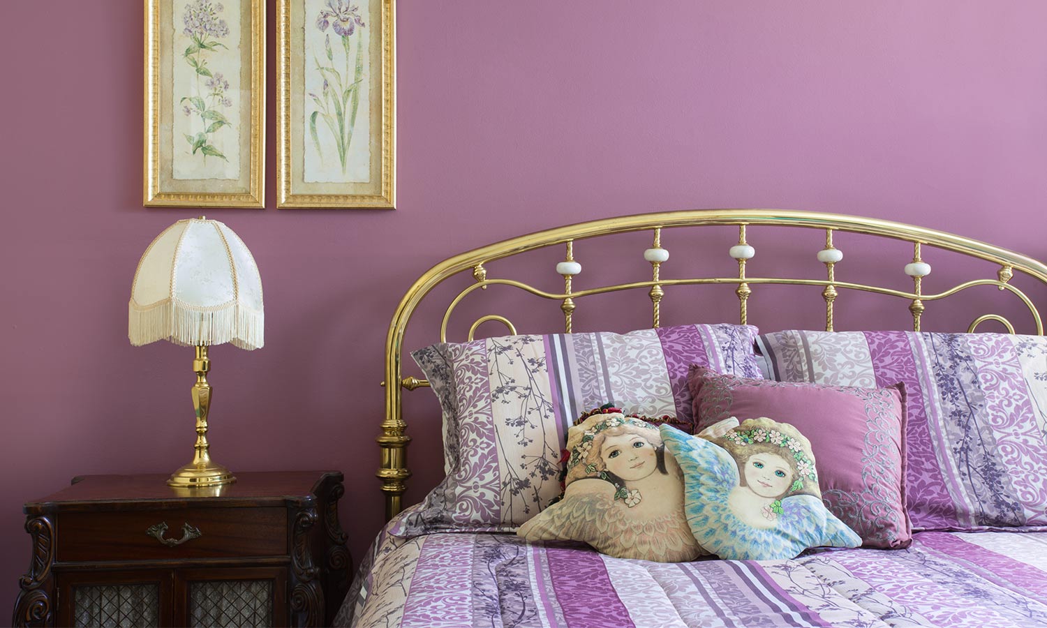 A rounded brass headboard and frame