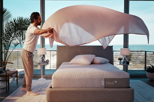 Man putting the cooling sheet on the bed